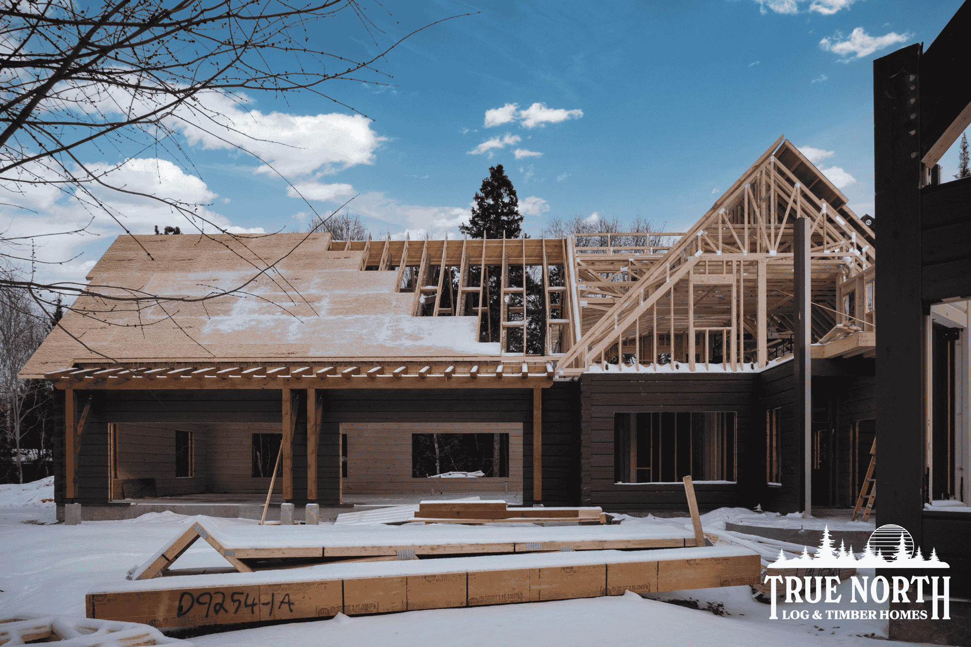 An in-progress image of a 10,000 sq. ft. log and timber home under construction in Sudbury, Ontario, showing that our homes respond as expected even when exposed to the elements.